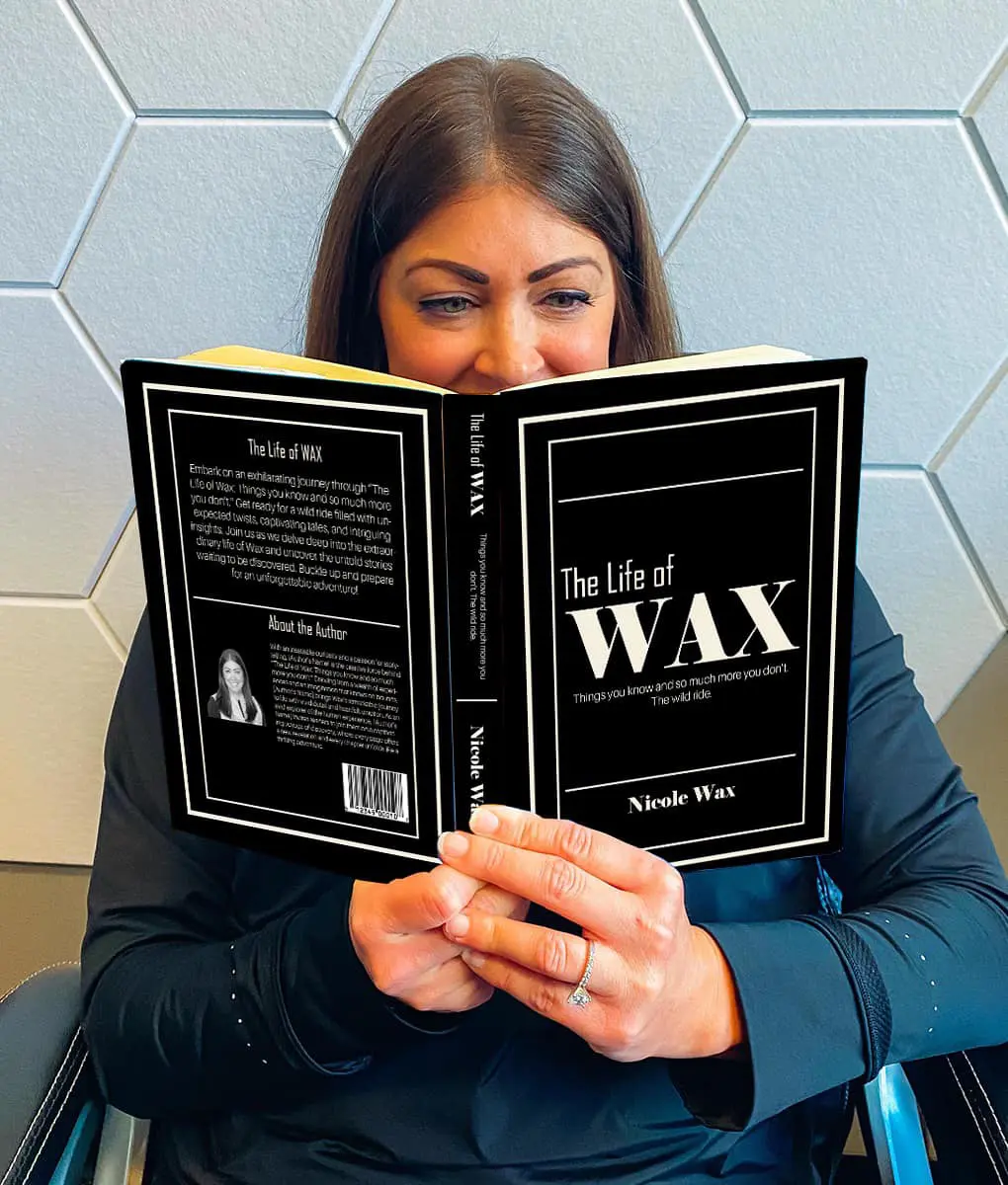 Person enjoys a moment of relaxation reading The Life of WAX in a comfortable setting.