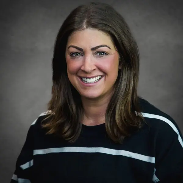 Orthodontic team member with a warm smile radiates approachability and care.