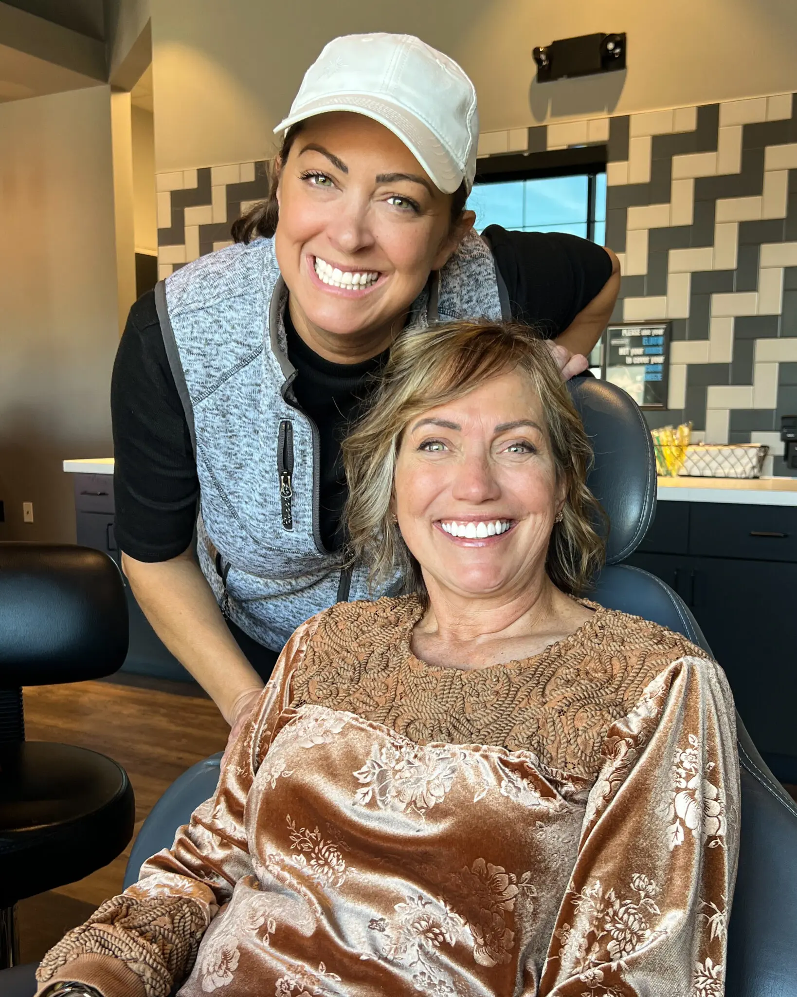 Warm, caring moment as a patient smiles with a supportive team member at Dr. Wax Orthodontics.