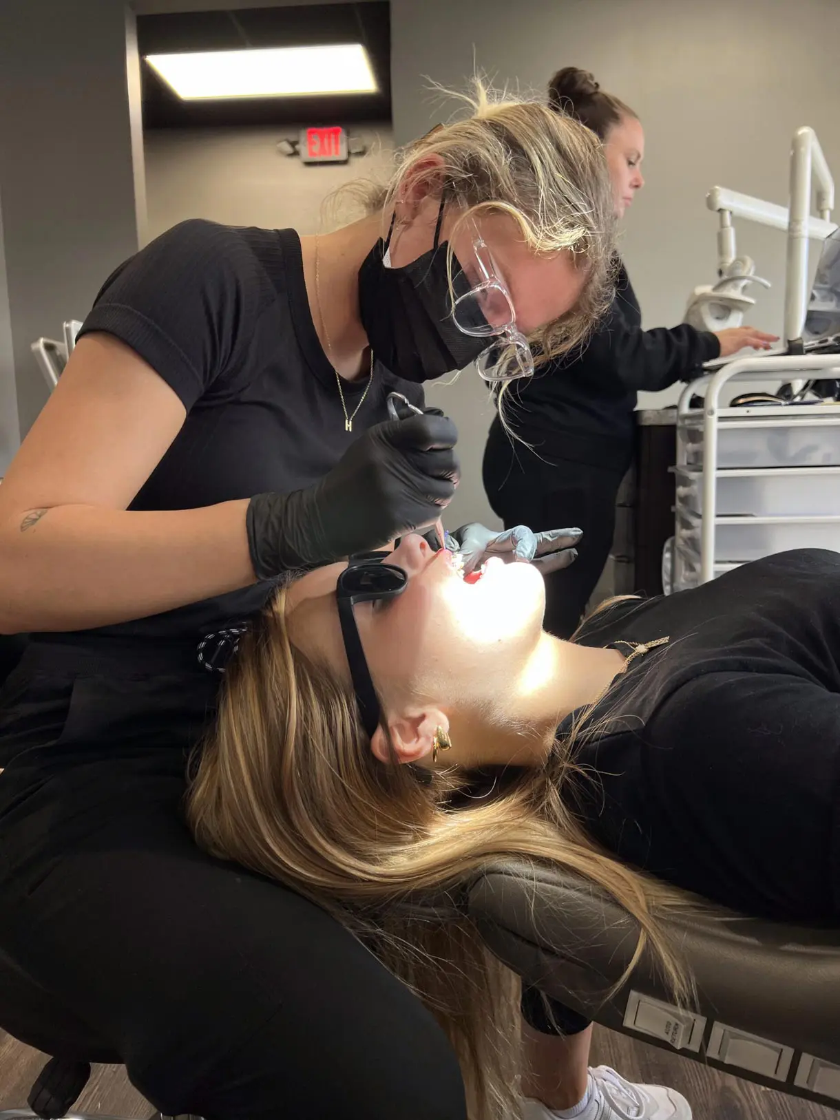 Orthodontist caring for a patient during a dental appointment, ensuring a comfortable experience.