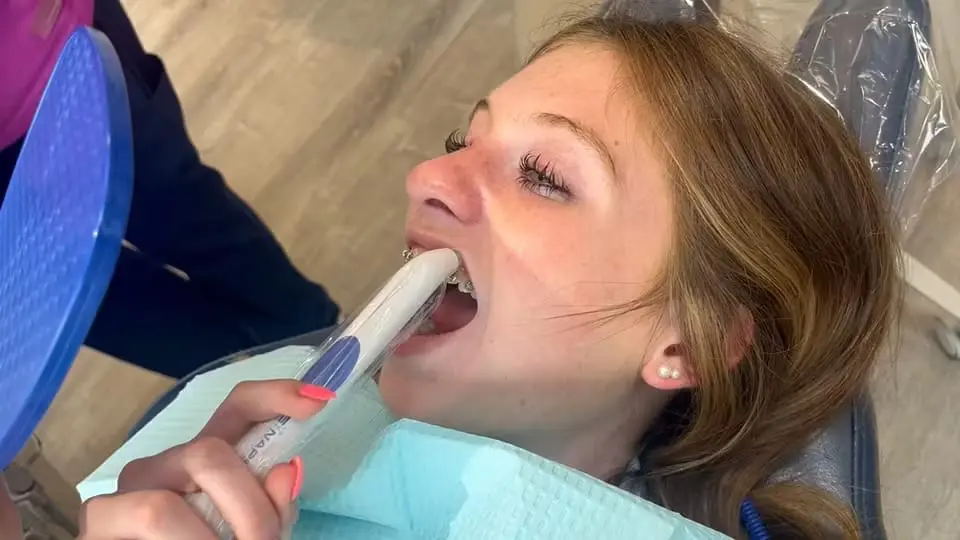 Teen using an orthodontic device, feeling comfortable and cared for.