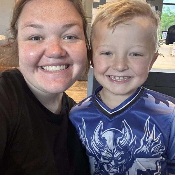 Warm smiles of a happy team member and child at Dr. Wax Orthodontics.