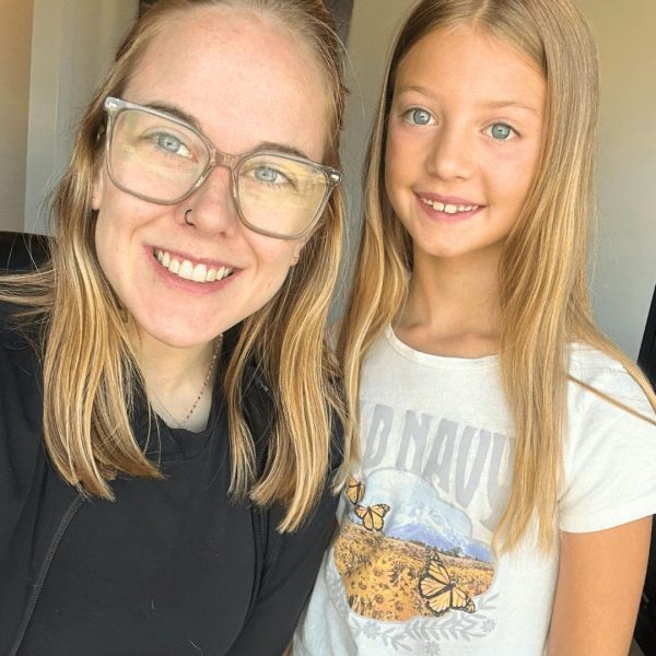 A smiling orthodontist and young patient share a moment of comfort and care at Dr. Wax Orthodontics.