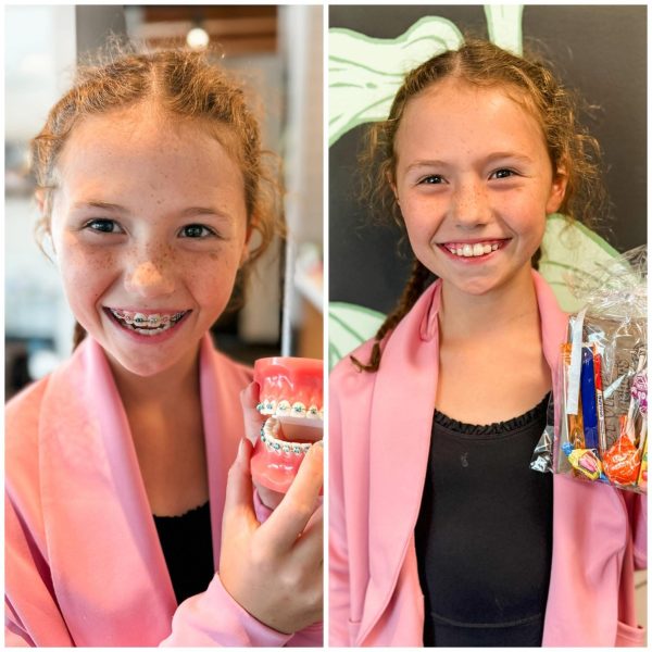 Child smiling with pride after orthodontic visit, holding model and gift bag, radiating confidence and joy.