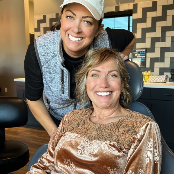 Warm, caring moment as a patient smiles with a supportive team member at Dr. Wax Orthodontics.