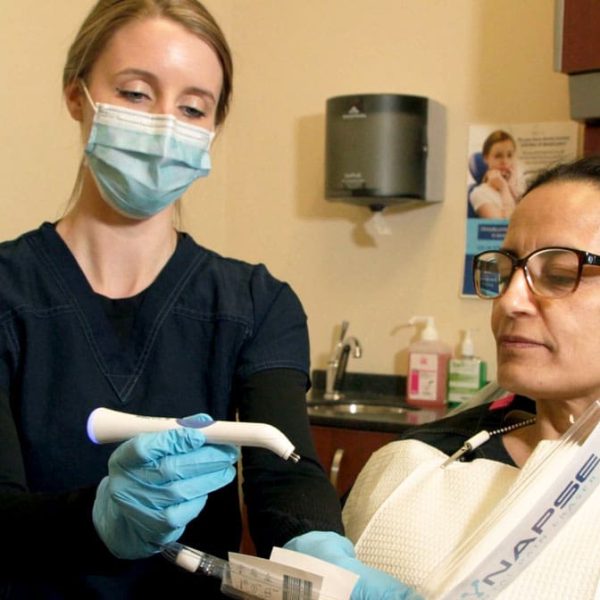 Orthodontic team member gently prepares a patient for treatment.