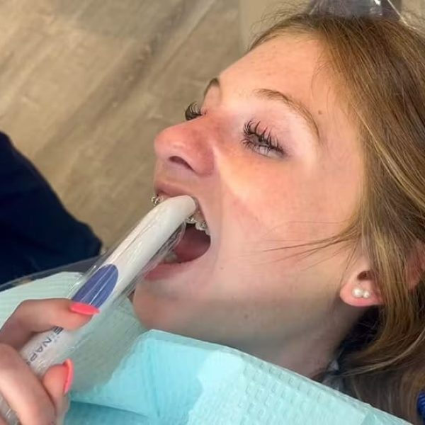 Teen using an orthodontic device, feeling comfortable and cared for.